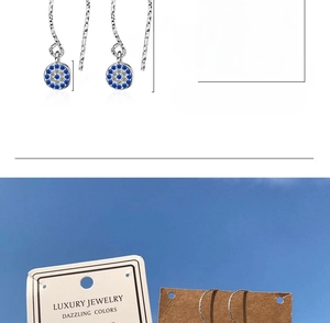 Detailed view of evil eye drop earrings with 30mm chain and blue zircon pendant