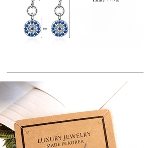 Detailed view of evil eye earrings with size dimensions and silver plated finish