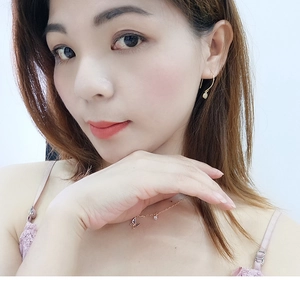 Detailed view of butterfly-shaped gold necklace and earrings set on a model