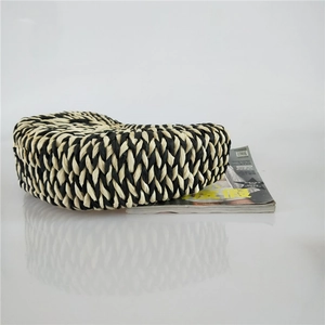 Detail of the high-quality bicolor woven straw bag bottom with a unique semicircular pattern