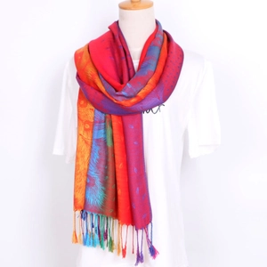 Detail of colorful ethnic floral jacquard pattern and handmade tassels on soft scarf