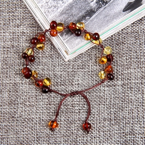 Handwoven natural amber bracelet with adjustable cord and multi-color gemstones for babies