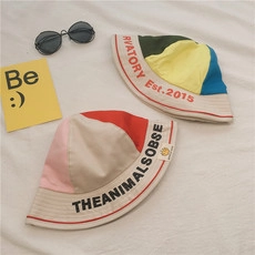 Detailed flat lay of colorful patchwork canvas bucket hats with artistic prints