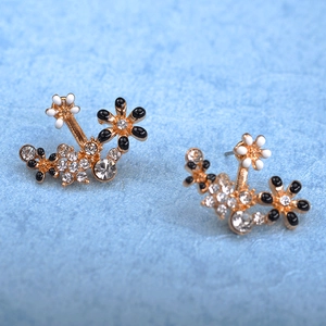 Floral stud earrings featuring black and white enamel flowers with crystal accents