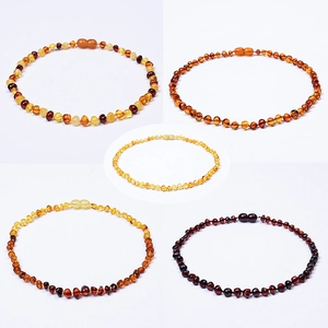 Polished Baltic amber beaded necklaces in yellow, honey, and dark brown natural colors