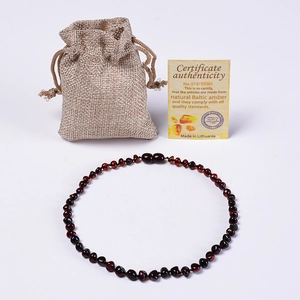 Natural Baltic amber necklace shown with linen pouch and authenticity certificate