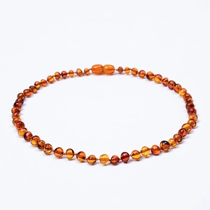 Macro view of polished Baltic amber necklace beads with natural irregular textures