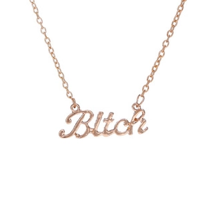 Macro shot of rose gold Bitch letter pendant necklace with fine cable chain
