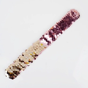 Detail showing pink and gold reversible sequins on a Christmas snap bracelet wristband