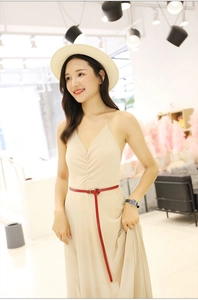 Slim red genuine leather waist belt styled on a beige dress with vintage buckle