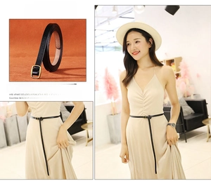 Detail of slim black leather belt for women featuring a minimalist gold square buckle