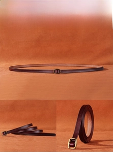 Detailed macro view of slim coffee leather belt featuring a vintage gold square buckle