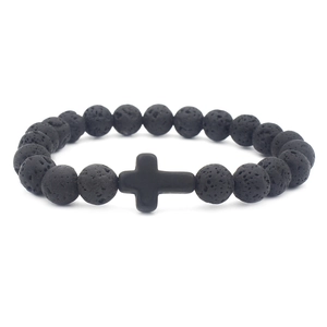 Lava stone bead bracelet with black cross charm on a clean white background