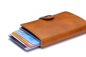 Detail view of brown PU leather card holder with automatic aluminum pop-up card mechanism