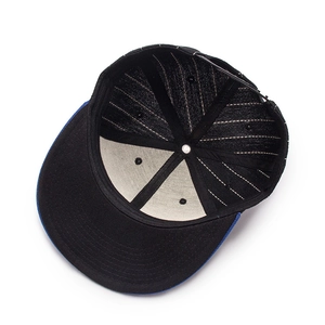 Internal view of black and blue baseball cap showing stitching and breathable eyelets