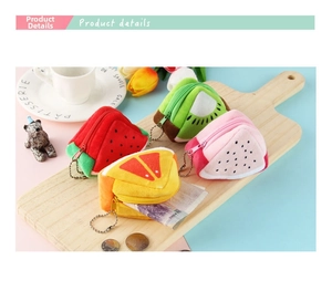 Detail showing plush fruit coin purses in watermelon and orange styles holding cash and coins