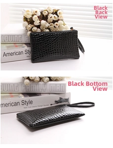 Detail view of black crocodile pattern clutch bag showing rear side and bottom structure
