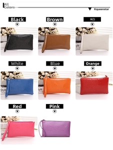 Detail showing eight colors of crocodile pattern clutches with wrist straps and metal zippers