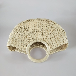 Macro detail of natural straw semi-circular handbag with handmade woven texture