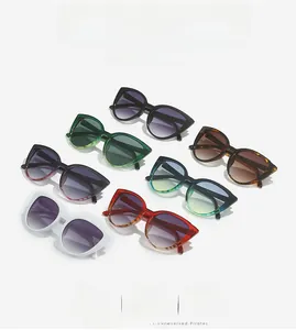 Flat lay of retro cat eye sunglasses in seven colors including black, green, and tortoiseshell