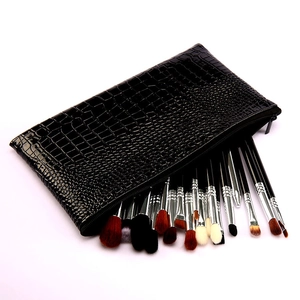 Detail of professional 19-piece eye makeup brush set with black crocodile leather case