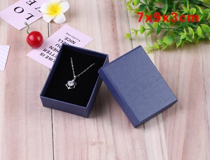 Detail of blue textured jewelry gift box sized 7x9x3cm with black velvet lining