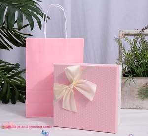 Detailed view of pink woven texture gift box with cream satin bow and matching paper bag