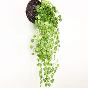Artificial hanging greenery plant in a woven basket for home and hotel wall decor