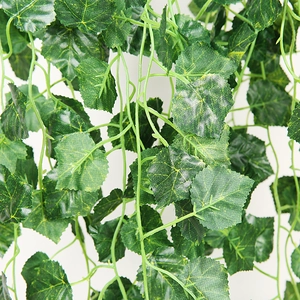 Macro detail of artificial green ivy leaves featuring realistic silk texture and veins