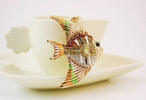 Close-up of tropical fish keychain with colorful rhinestones and black enamel stripes