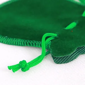 Detailed close-up of grass green velvet drawstring pouch with neat overlock stitching