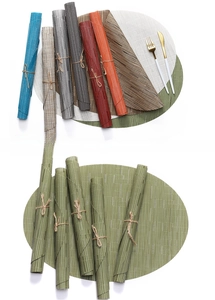Detail of multi-color woven PVC placemats showing heat-resistant texture and oval shape