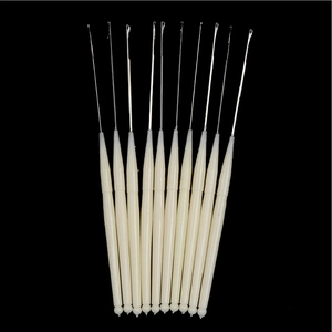 Macro view of 10 professional crochet hooks with cream handles on black background
