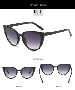 Detail view of cat eye sunglasses with black frame and purple gradient lenses