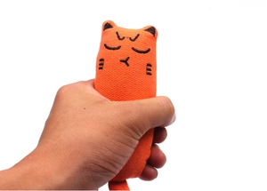Close-up of hand squeezing an orange cat plush toy to show soft elastic cotton fabric
