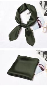 Detailed view of dark green silk satin scarf showing smooth glossy texture and bow knot