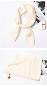 Detailed view of champagne satin silk scarf with a smooth texture and soft glossy finish