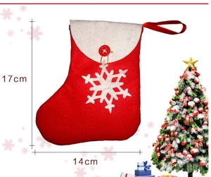 Detailed view of red Christmas stocking with snowflake decoration and 17x14cm size markings
