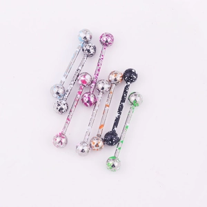 Polished stainless steel tongue rings with colorful splatter paint patterns on white background