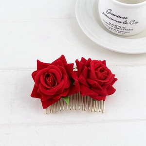 Close-up of red velvet double rose floral hair comb with elegant gold metal prongs
