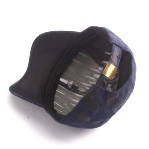 Detail view of the blue camouflage cap interior with golden metal adjustment buckle