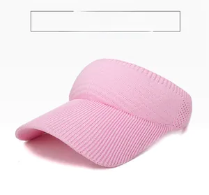 Detail of pink knitted visor hat showing ribbed texture and breathable mesh fabric