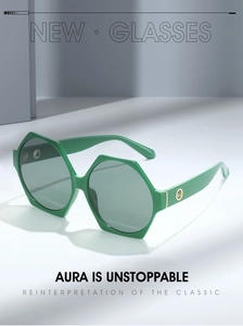 Detail of green hexagonal sunglasses with dark grey lenses and metal ring hinge decor
