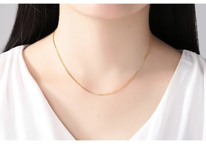 Close-up of 14K gold plated box chain necklace worn by a model for a stylish look