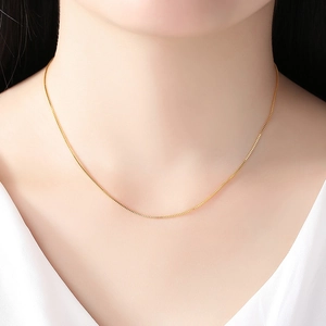 Elegant 14K gold plated water wave chain necklace shown on a female model neck