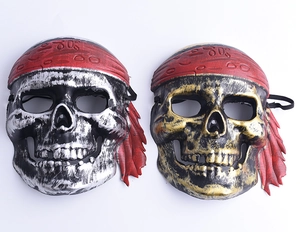 Detail of silver and gold pirate skull masks with red headscarf for Halloween parties