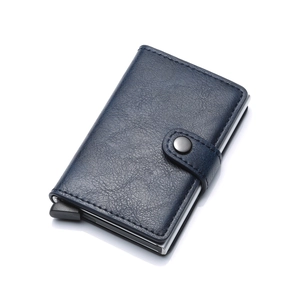 Detail of navy blue leather automatic pop-up card holder with metal ejector and snap button