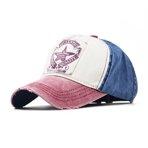Close-up of vintage tricolor cotton baseball cap with distressed brim and retro badge