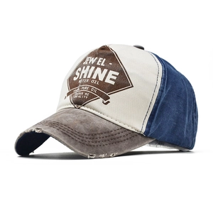 Detail of vintage baseball cap featuring distressed brim and Jewel Shine motor oil print