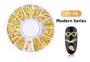 Macro detail of golden metal nail art charms featuring moon star and tower shapes in a storage box